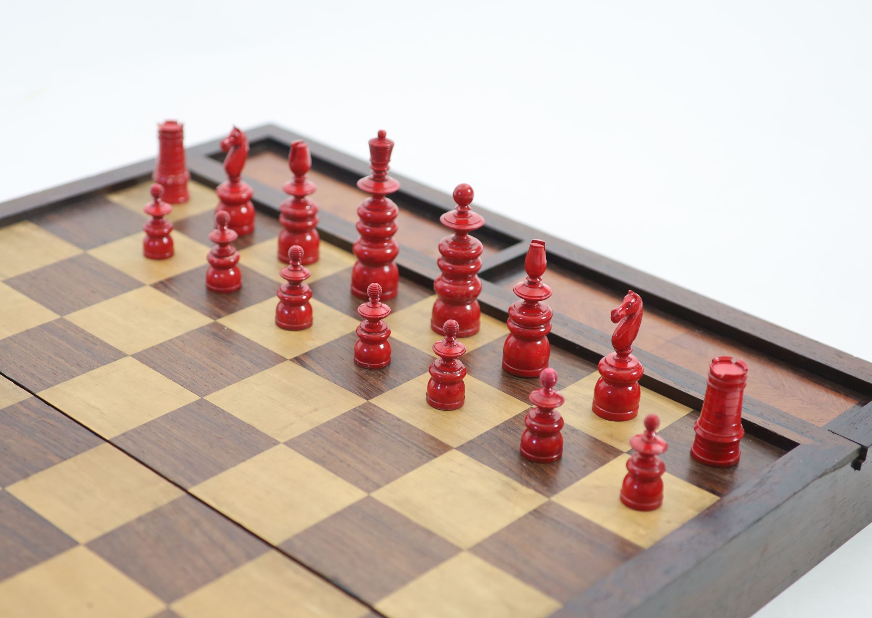 An early 20th century rosewood folding games board, external chess and internal backgammon, W 75cm D 56cm when open, W 75cm D 37cm when closed